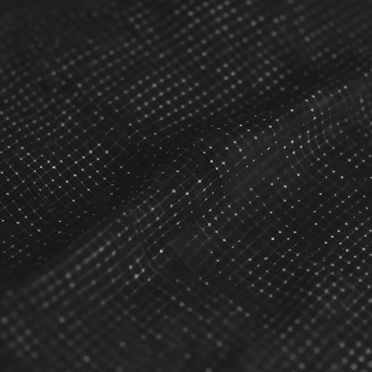 Close-up of a textured black surface with a grid pattern (Black)