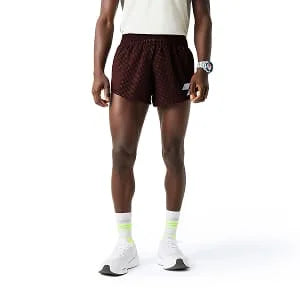 Man wearing maroon athletic shorts with white socks and sneakers