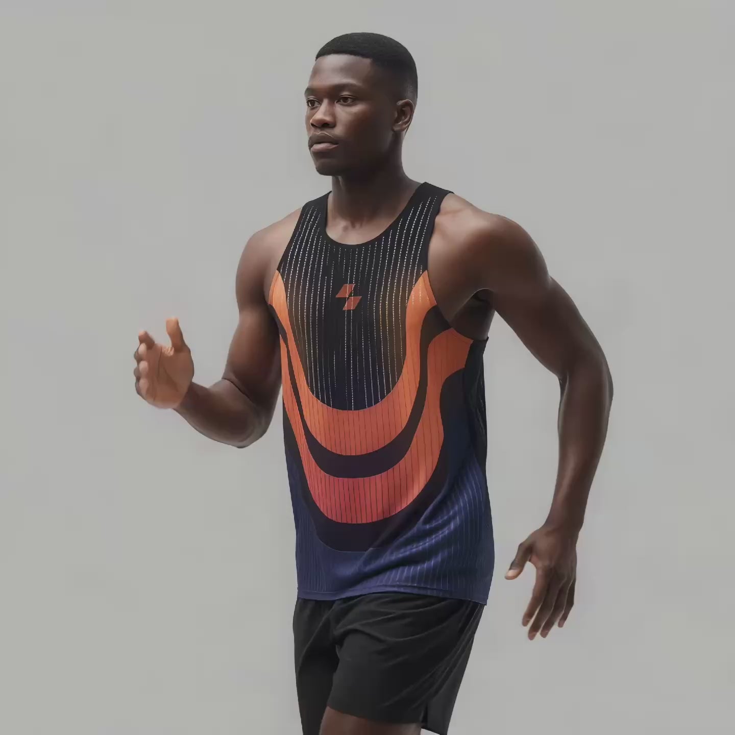 muscular Black man wearing a black and orange athletic tank top and black shorts is running against a light neutral background, with his right arm bent forward mid-stride and a focused expression on his face.