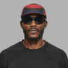 Multicolored cap with red, black, and blue design on a white background (Red)