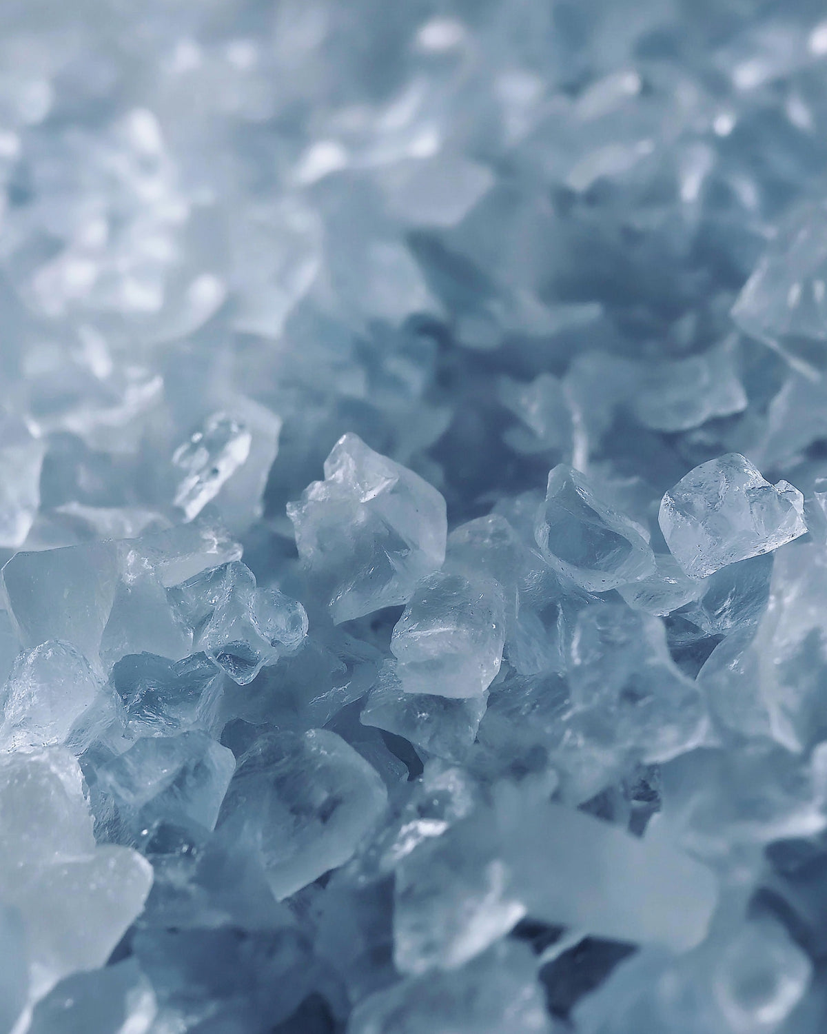 Close-up of clear crystal-like shapes on a blue background