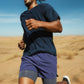 Person running in a desert landscape wearing a navy blue outfit (Blue)